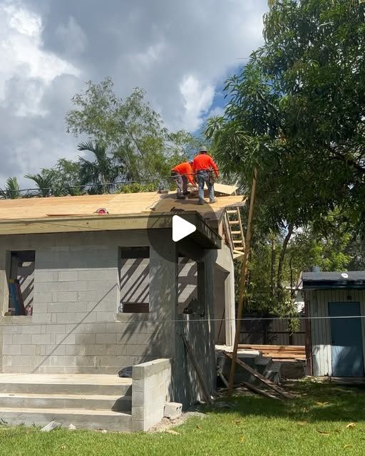Crew performing exterior work on a home